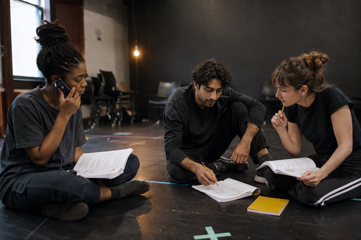 Drama students working through a scene together in a rehearsal studio